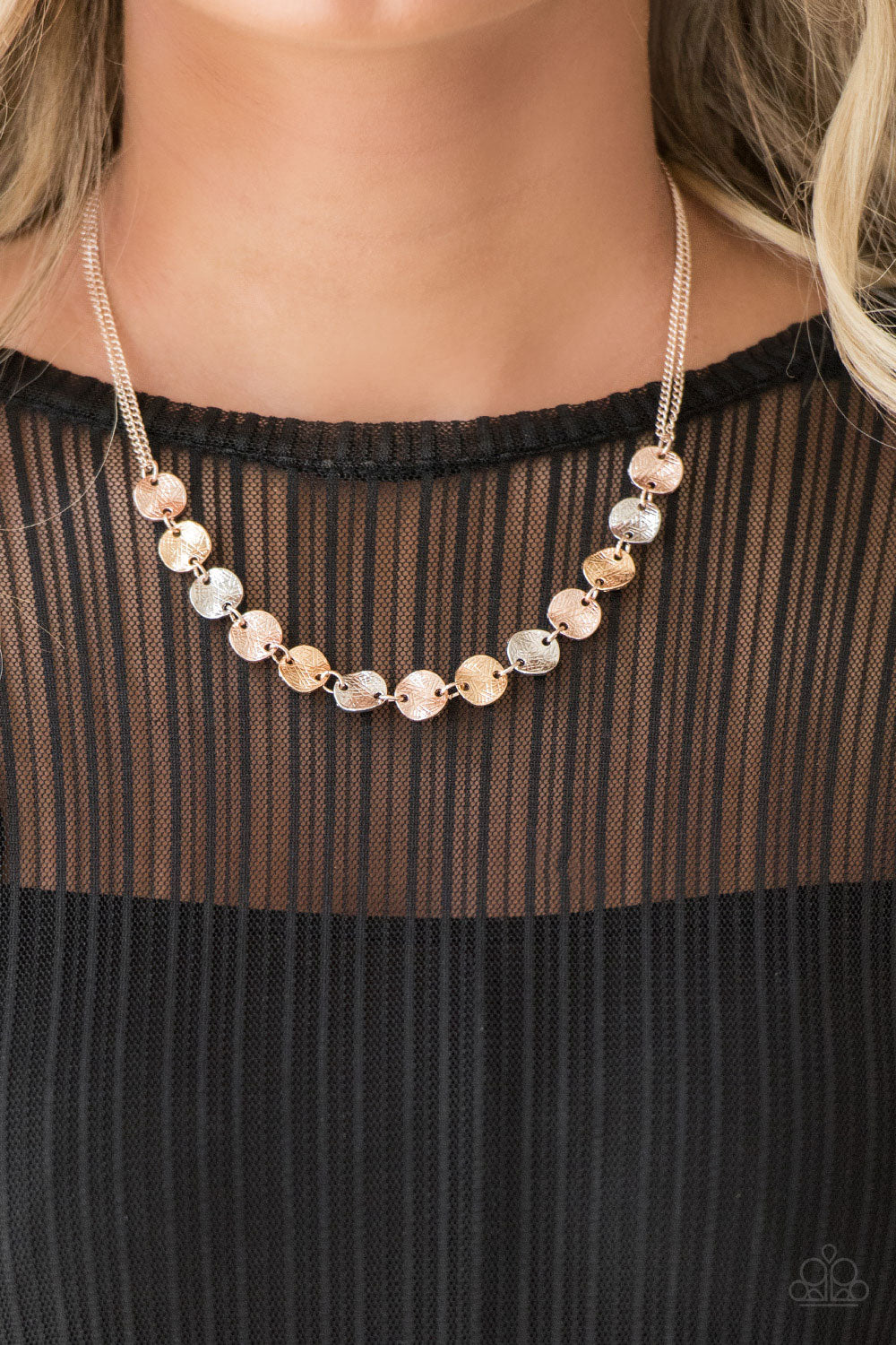 Delicately etched in linear textures, glistening silver, rose gold and gold discs link below the collar for a casual look. Features an adjustable clasp closure. Sold as one individual necklace. Includes one pair of matching earrings.