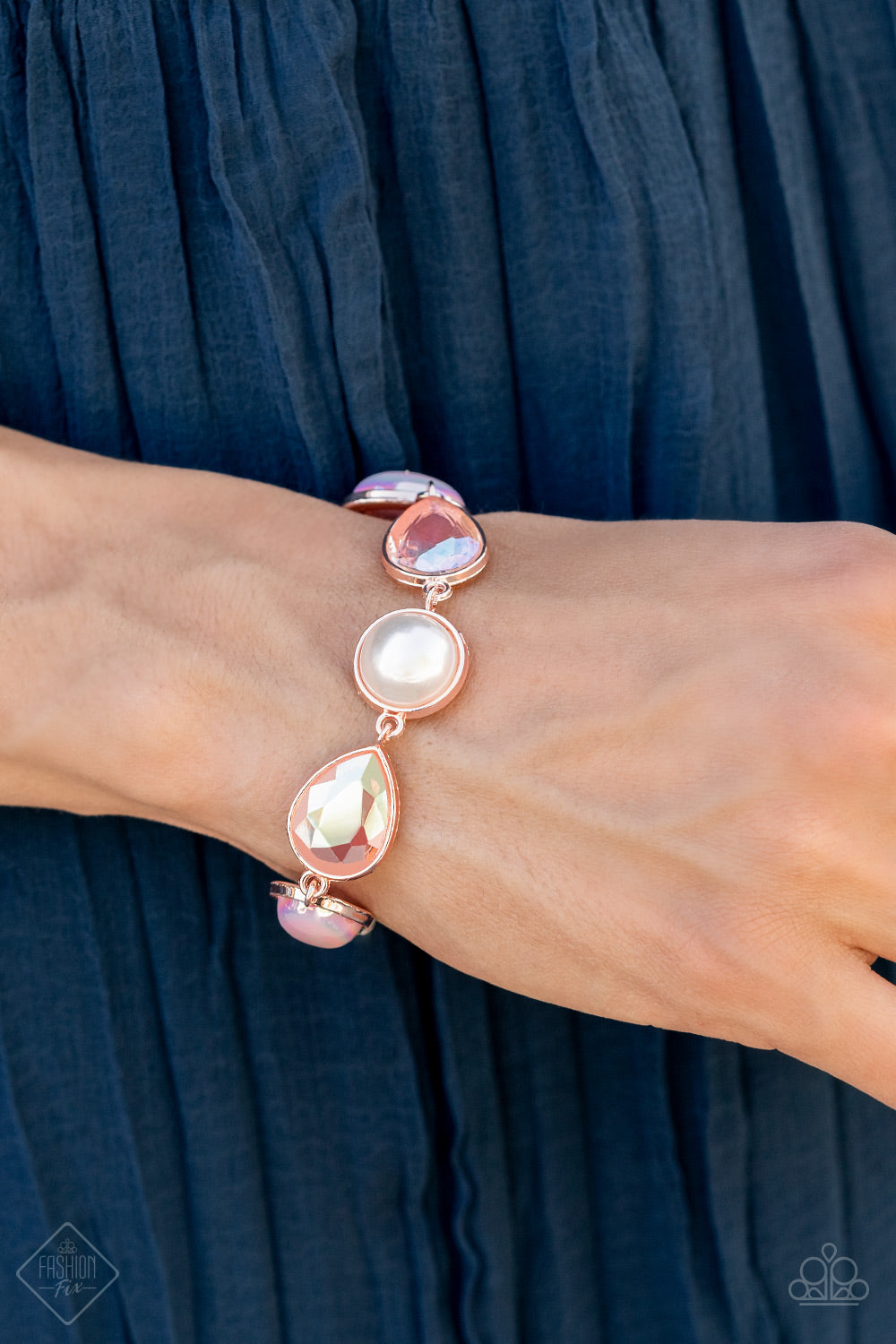 A collection of classic white pearls, Pale Rosette pearls glazed in a reflective finish, and iridescent teardrops wrap around the wrist in an ethereal display. Rose gold frames encase each bead, adding a romantic vibe to the vintage inspired design. Features an adjustable clasp closure. Sold as one individual bracelet.