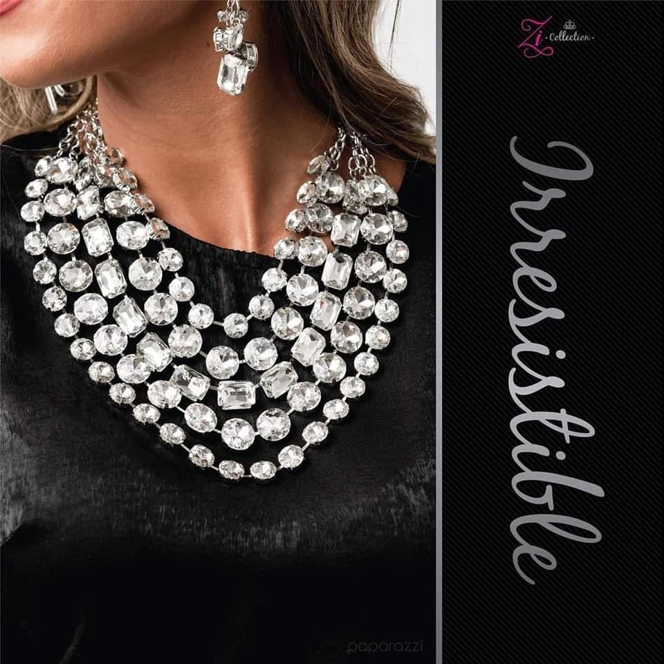 Item #Z2015 Featuring round and emerald style cuts, row after row of dramatically oversized white rhinestones delicately link into blinding layers below the collar. Featuring sleek silver fittings, each rhinestone in this megawatt mashup demands attention. Features an adjustable clasp closure. Sold as one individual necklace. Includes one pair of matching earrings. New Kit