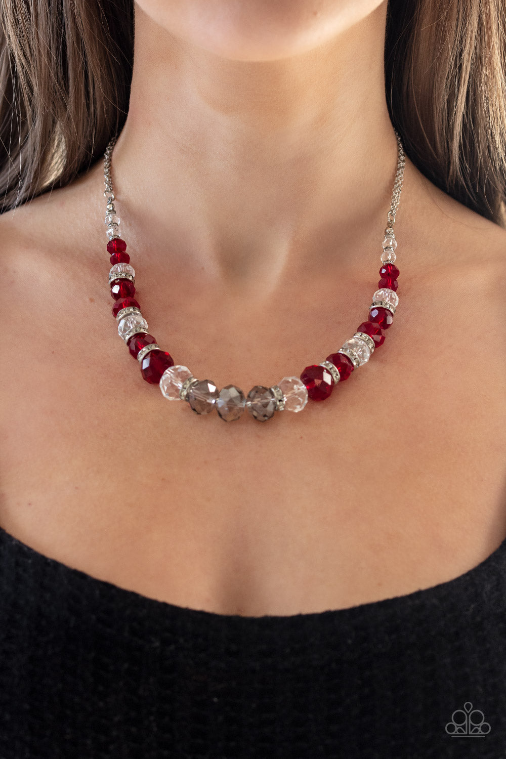Item #P2RE-RDXX-167XX Attached to strands of shimmery silver chains, a glittery collection of red, smoky, and white crystal-like gems and white rhinestone encrusted silver rings are threaded along an invisible wire below the collar for a glamorous finish. Features an adjustable clasp closure. Sold as one individual necklace. Includes one pair of matching earrings.