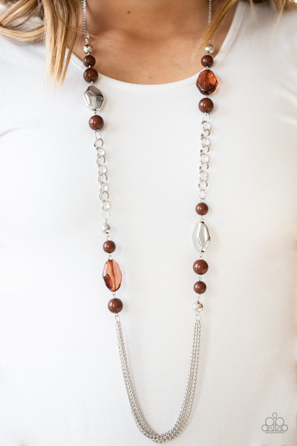Item #P2WH-BNXX-202XX A collection of faceted silver, crystal-like brown, polished brown, and silver beads give way to layers of shimmery silver chains for a whimsical look. Features an adjustable clasp closure. Sold as one individual necklace. Includes one pair of matching earrings.