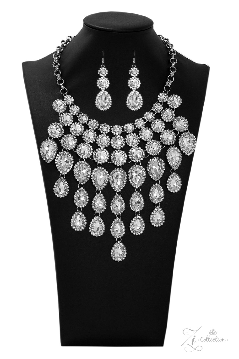 tem #Z916 Encrusted in dainty white rhinestone frames, columns of glassy white gem studded frames increase in size as they drip below the collar. Varying in size and number, white rhinestone encrusted teardrop gems link together as they trickle down the chest , creating a plunging fringe for a ,mesmerizing finish. Features an adjustable clasp closure. Sold as one individual necklace. Includes one pair of matching earrings.