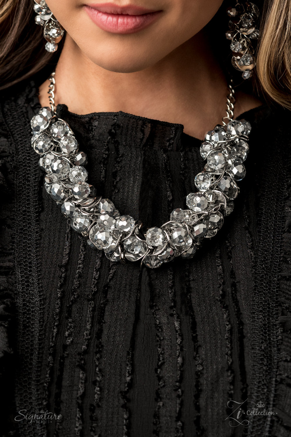 Item #Z2006 A brazen collection of metallic dipped crystal-like beads and delicately bent silver discs boldly cluster into a fearless fringe below the collar. The exaggerated display of jam-packed sparkle takes glitter to a whole new level with its unapologetic attitude. Features an adjustable clasp closure. Named after 2020 Rock the Runway winner, Haydee, F. Sold as one individual necklace. Includes one pair of matching earrings. The Haydee New Kit
