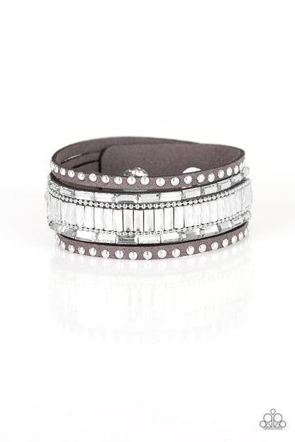 Shiny silver studs, dainty silver ball chains, and edgy white emerald-cut rhinestones race along a spliced gray suede band for a rock star look. Features an adjustable snap closure.  Sold as one individual bracelet.